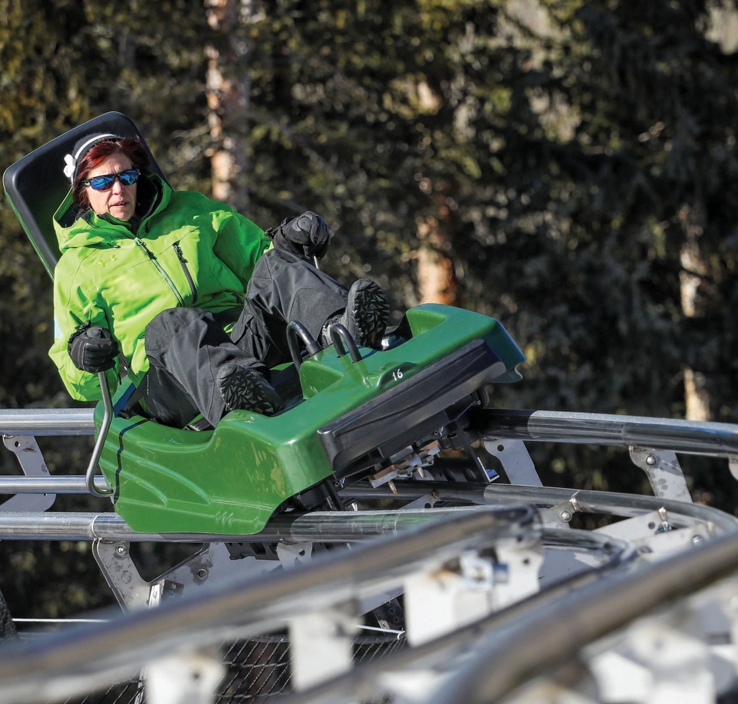 Lady in green riding mountain coaster