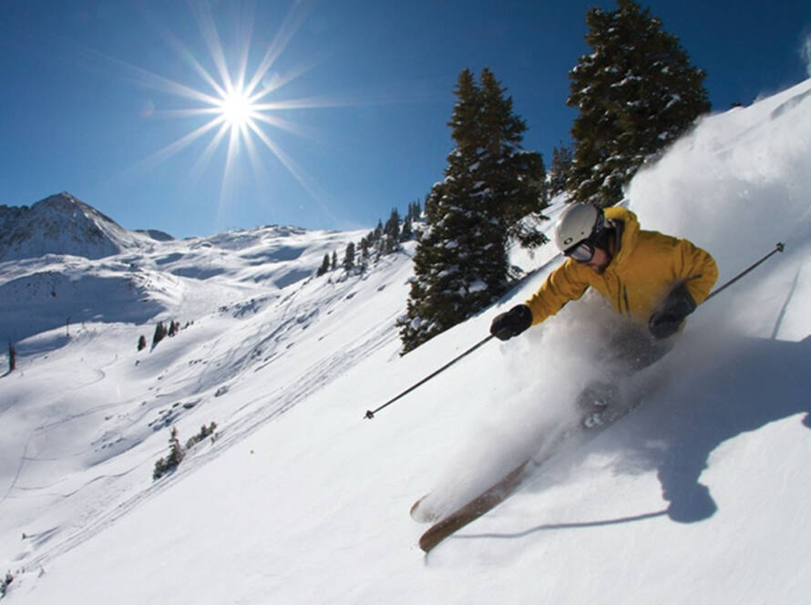 Skier carving fresh snow