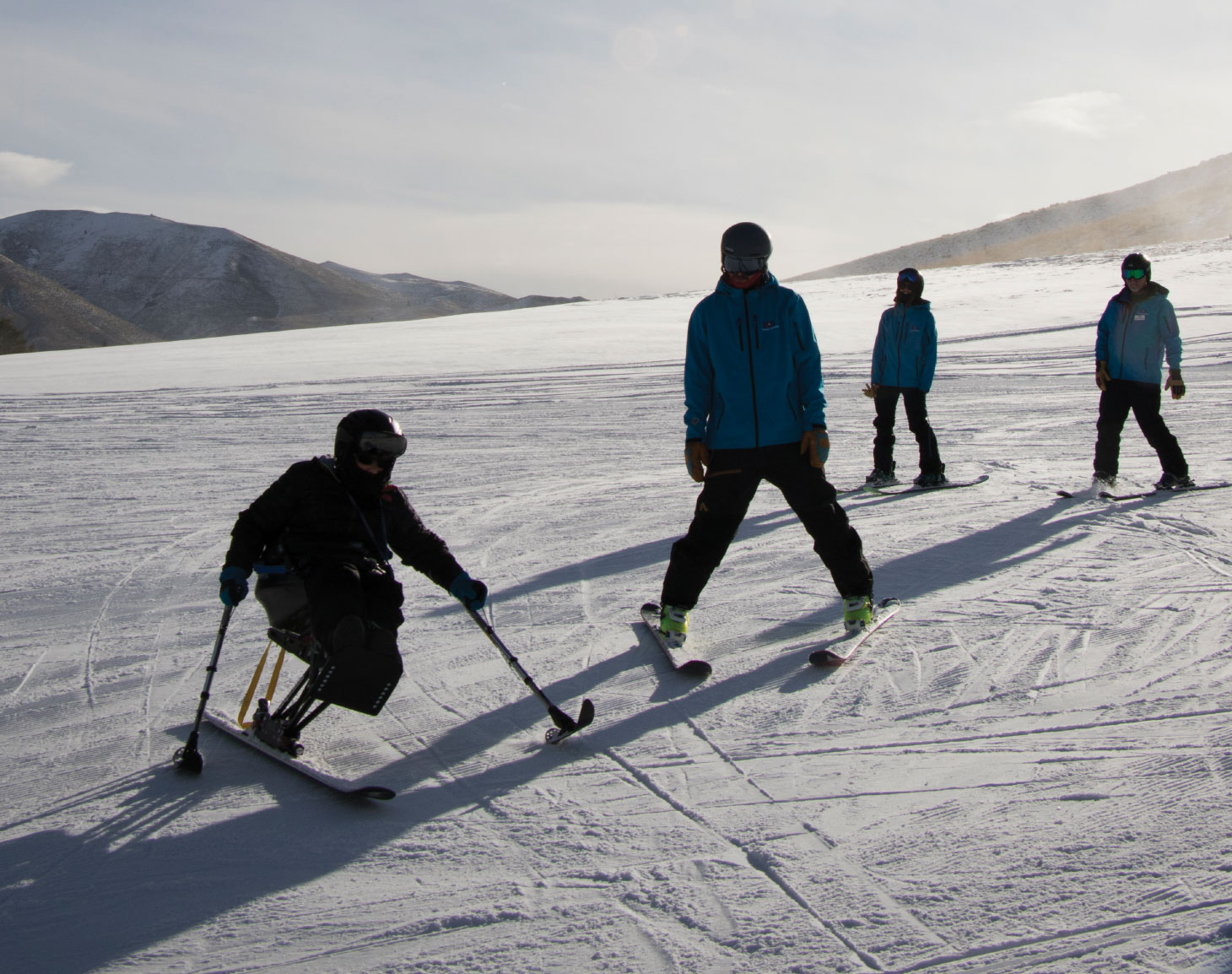 Skiers and snowboarders on sunny slope