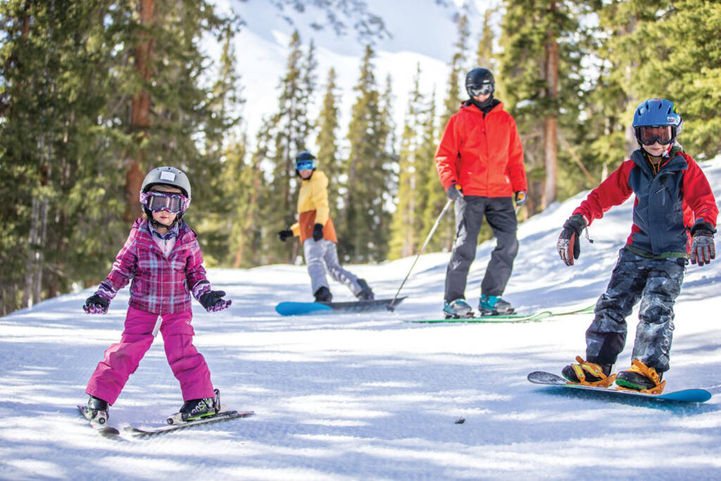 Various ski and snowboarders