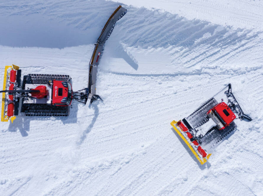 Snow grooming machines grooming the snow