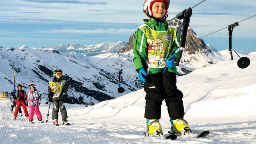 Young skiers on rope lift