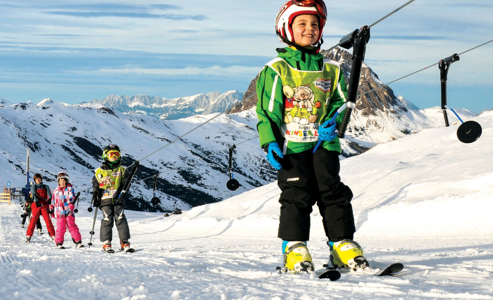 Young skiers on rope lift