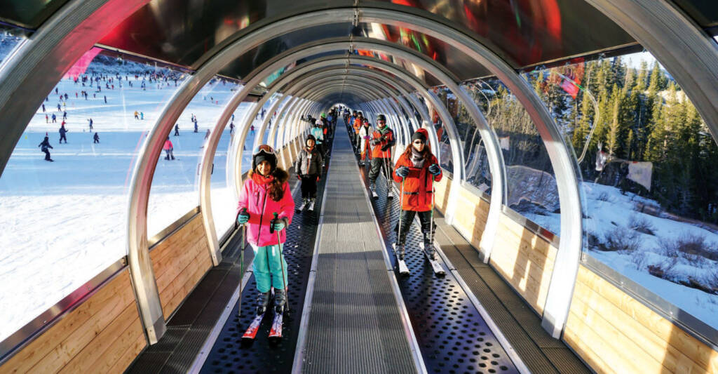 Young skiers on conveyor lift