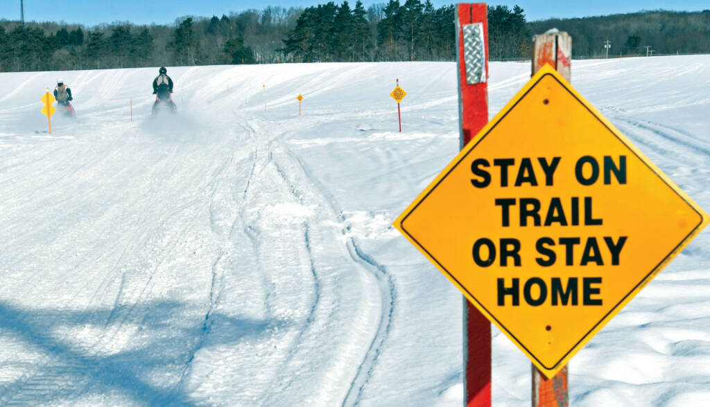 Sign that reads "Stay on trail or stay home"