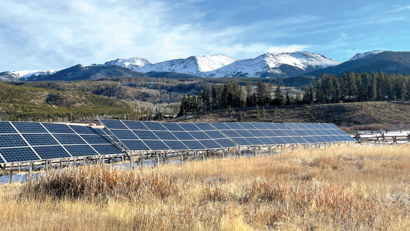 Solar panels with mountainside in background
