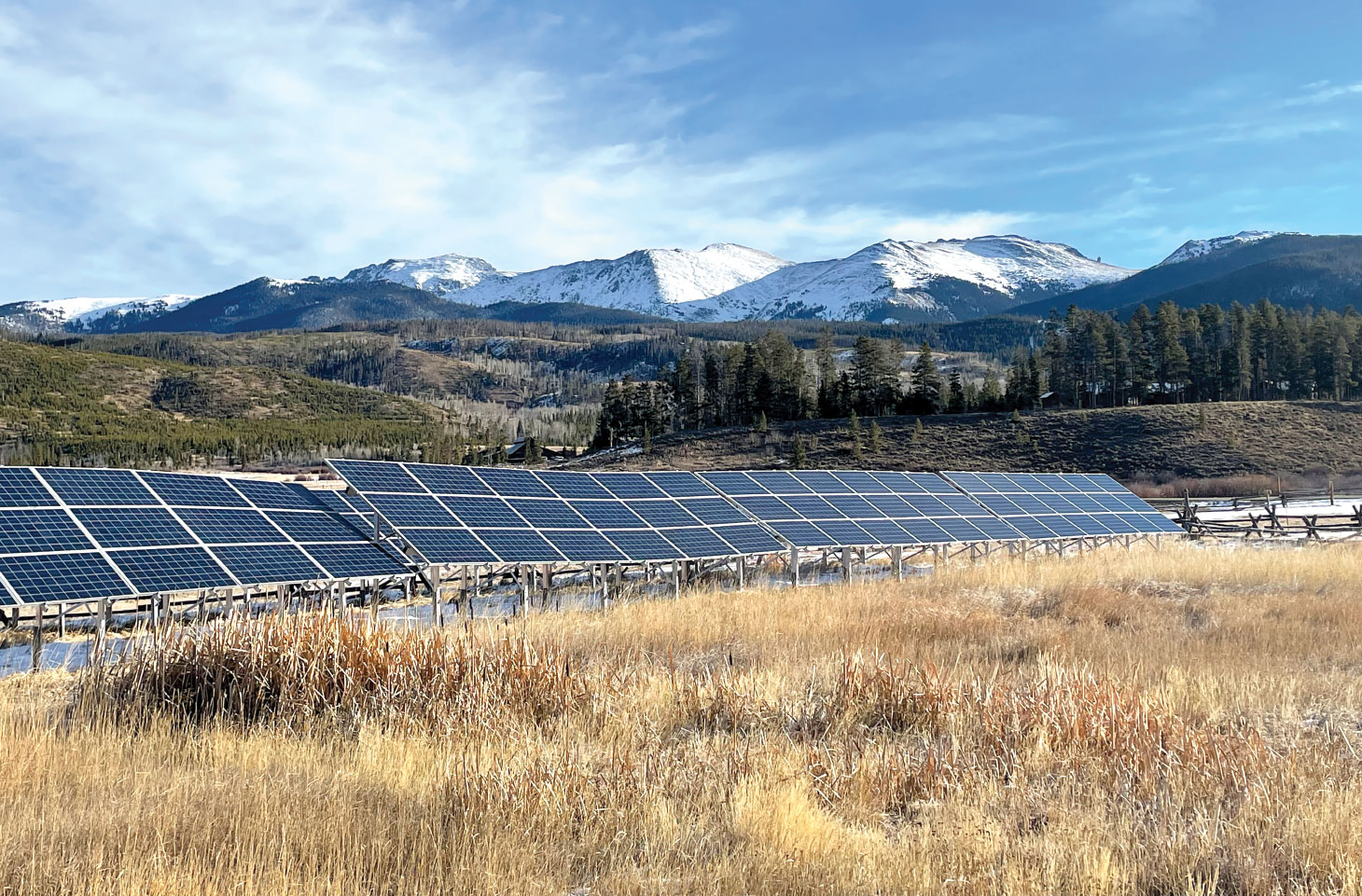 Solar panels with mountainside in background