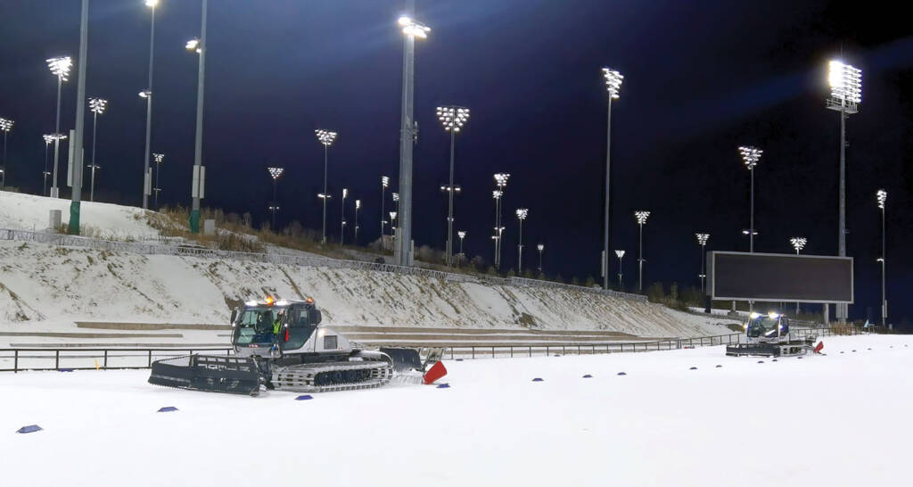 Snow grooming machines in outdoor stadium