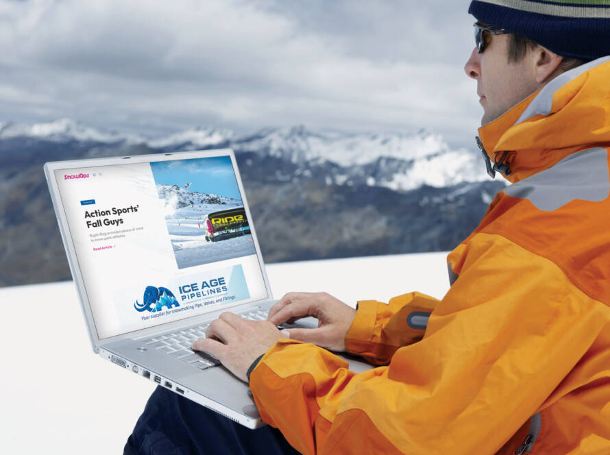 Snowboarder with laptop on mountain