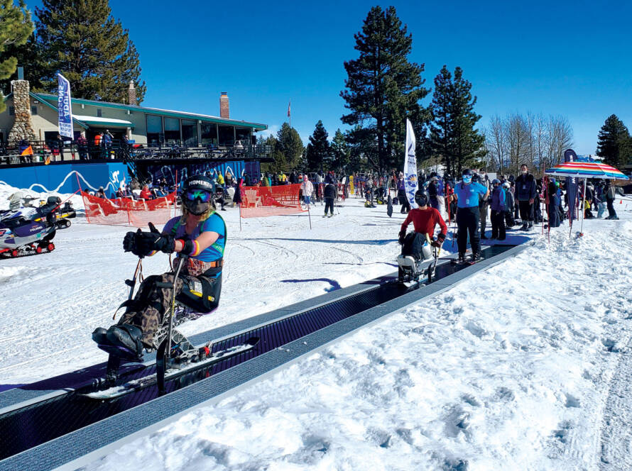Skiers with disabilities on carpet lift