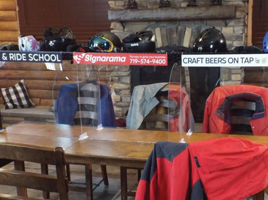 Table with signs on display and jackets on chairs