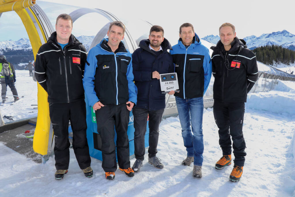 Group standing with certificate of 4,000th moving carpet installation