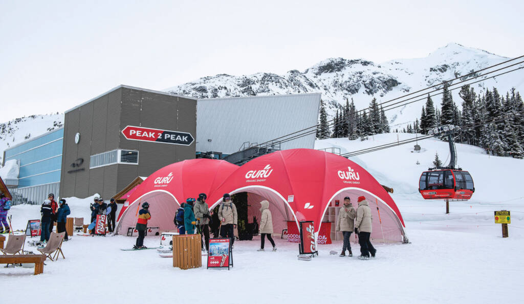 Red vendor tents at base of ski lift