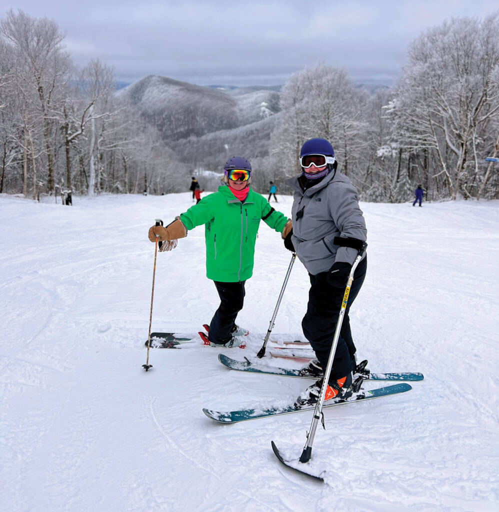 Two skiers on ski run