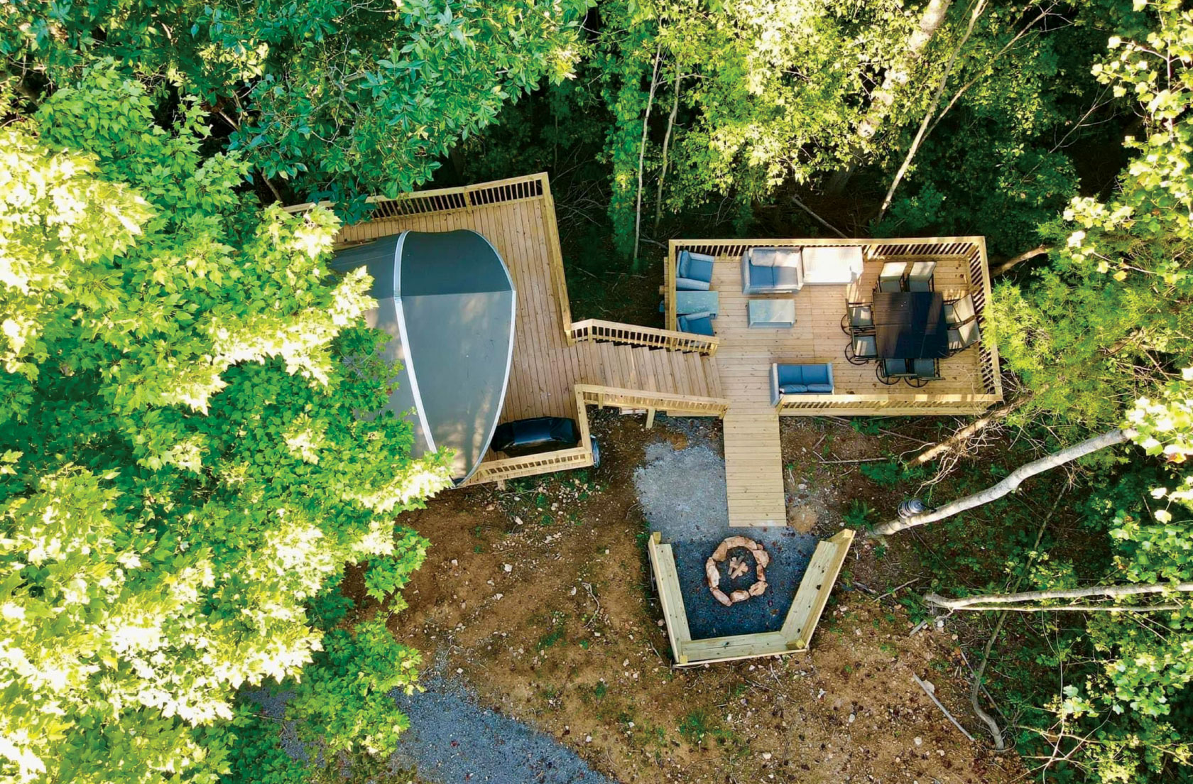 Overhead aerial view of wood deck, chairs and fire pit