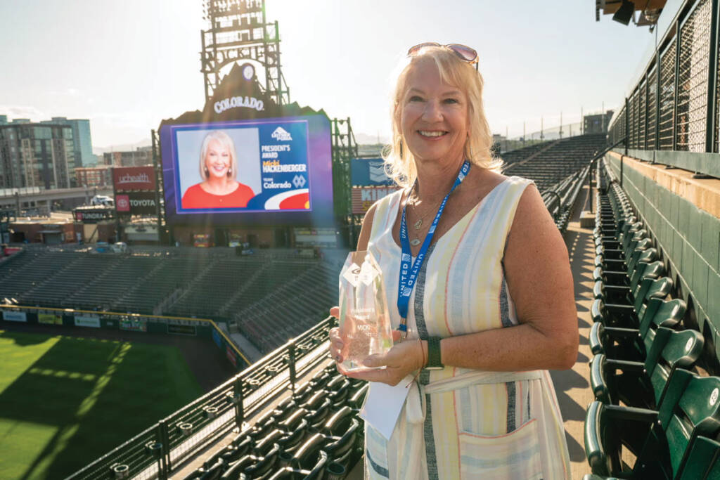 Micki Hackenberger posing with award