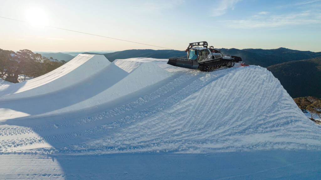 Snow groomer at top of ski ramp