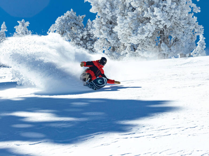 Snowboarder carving spray of snow