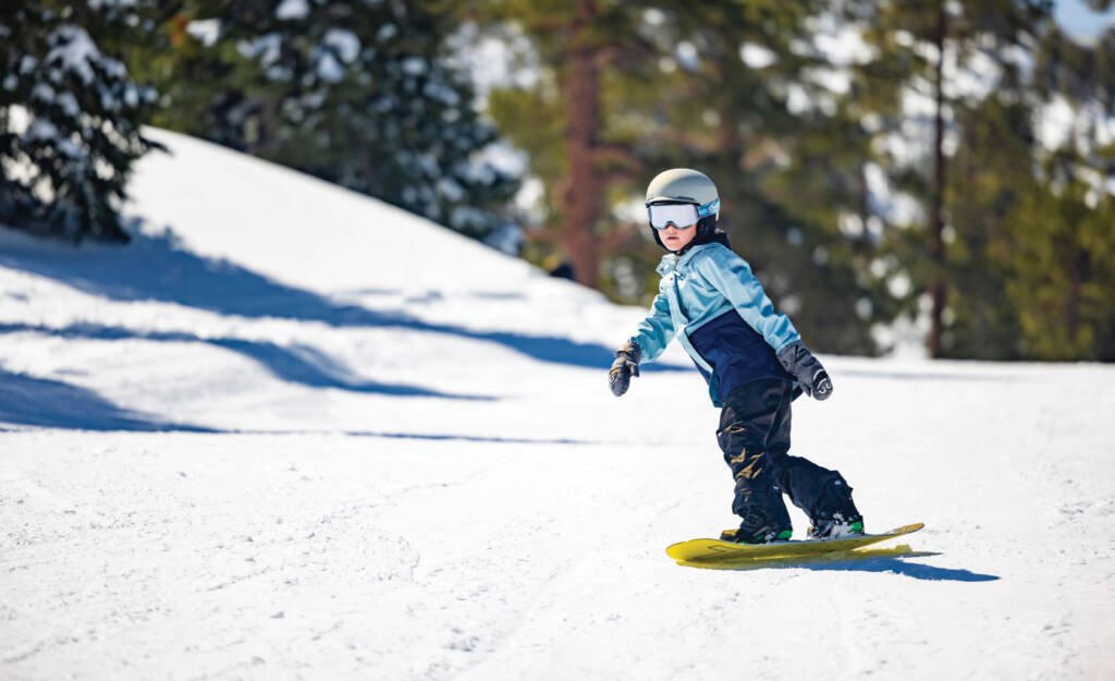 Young rider on snowboard