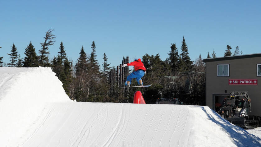 Snowboarder getting air in snowboard park