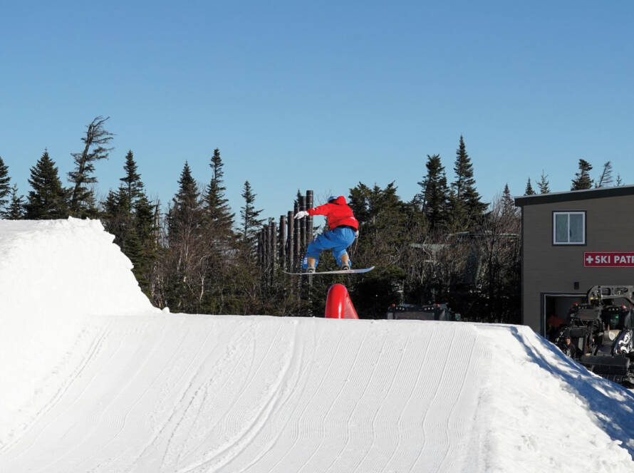 Snowboarder getting air in snowboard park