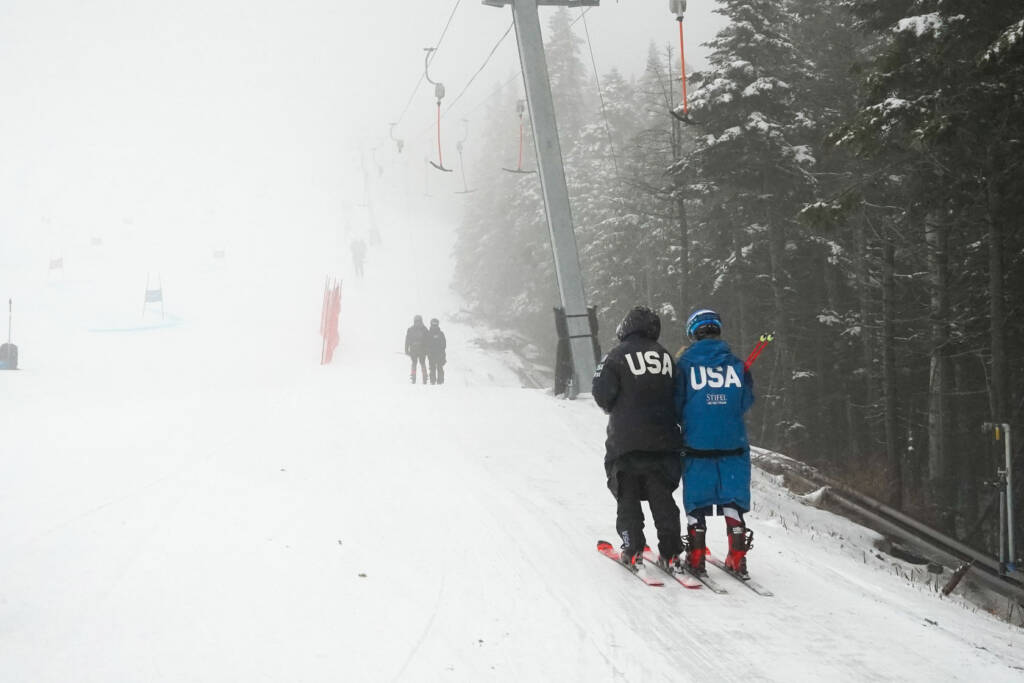 Two skiers in USA jackets on ski slope