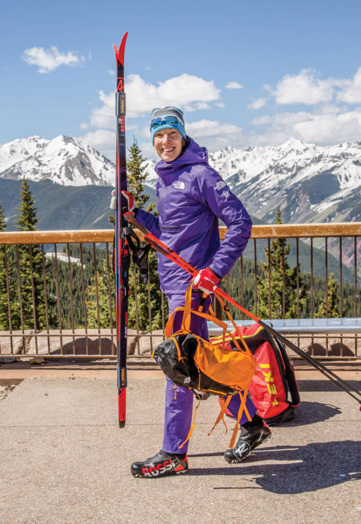 Emily Lovett carrying ski equipment