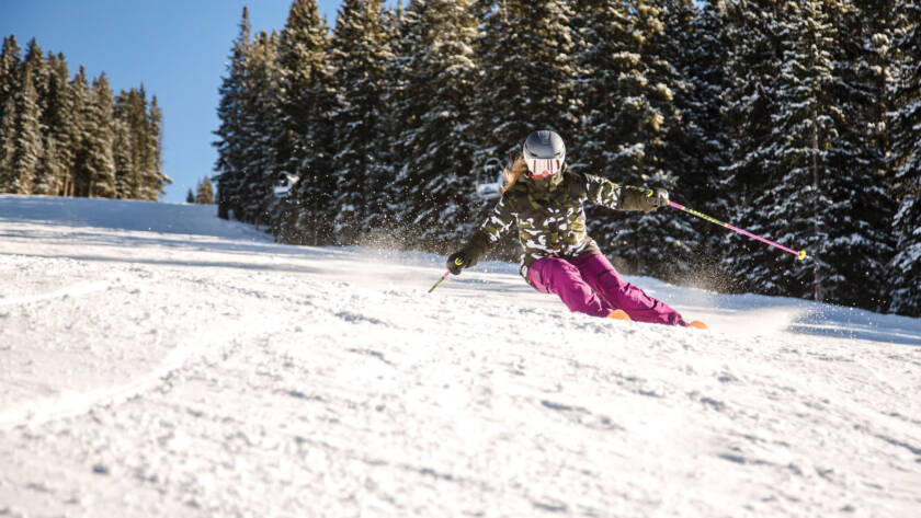 Skier carving down the slope