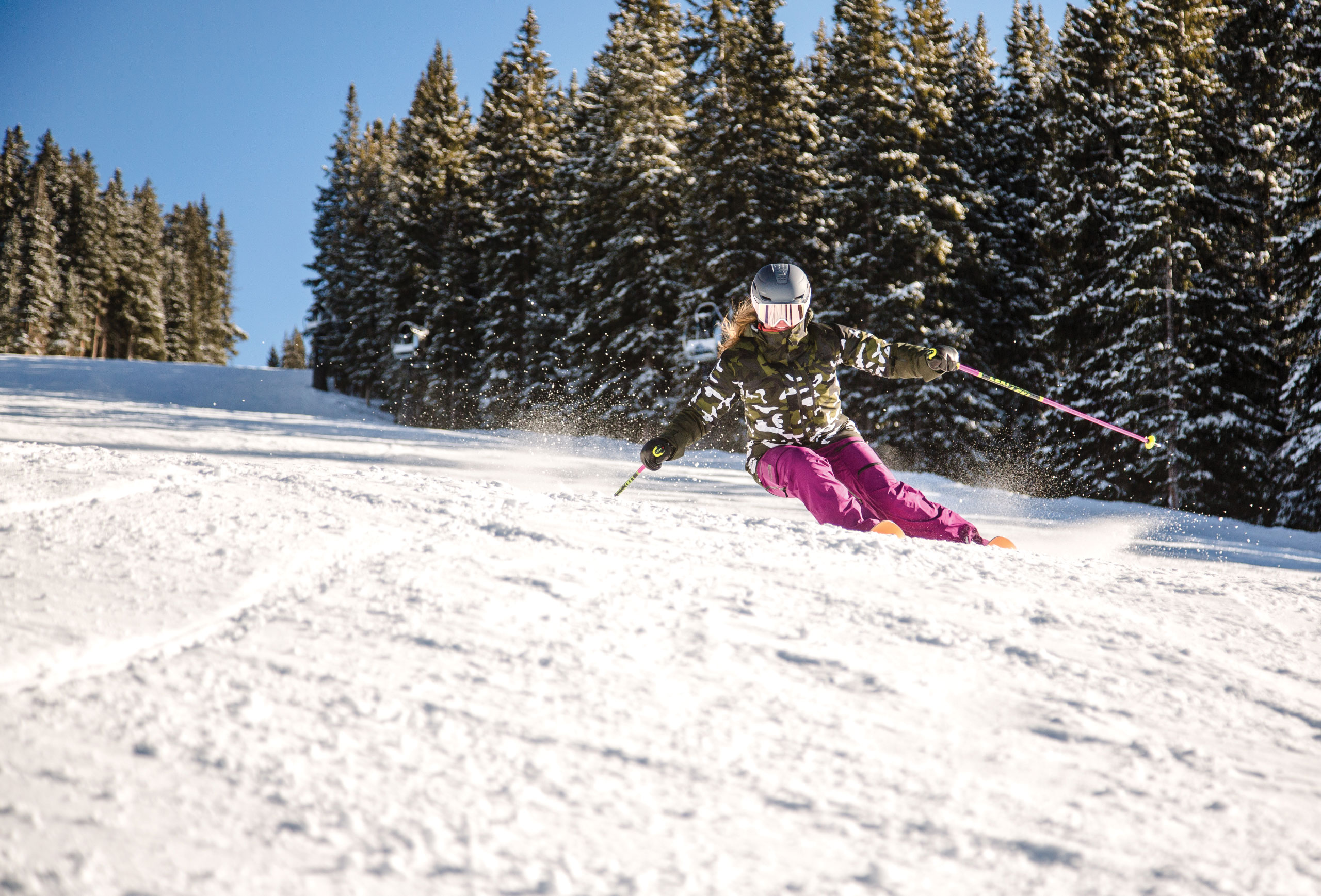 Skier carving down the slope